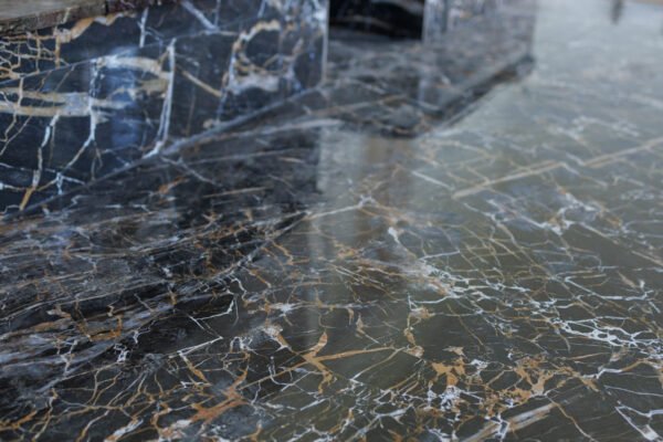 Black Marble with white and gold veins. Decorative tiles for finishing the fireplace during the renovation of an old house